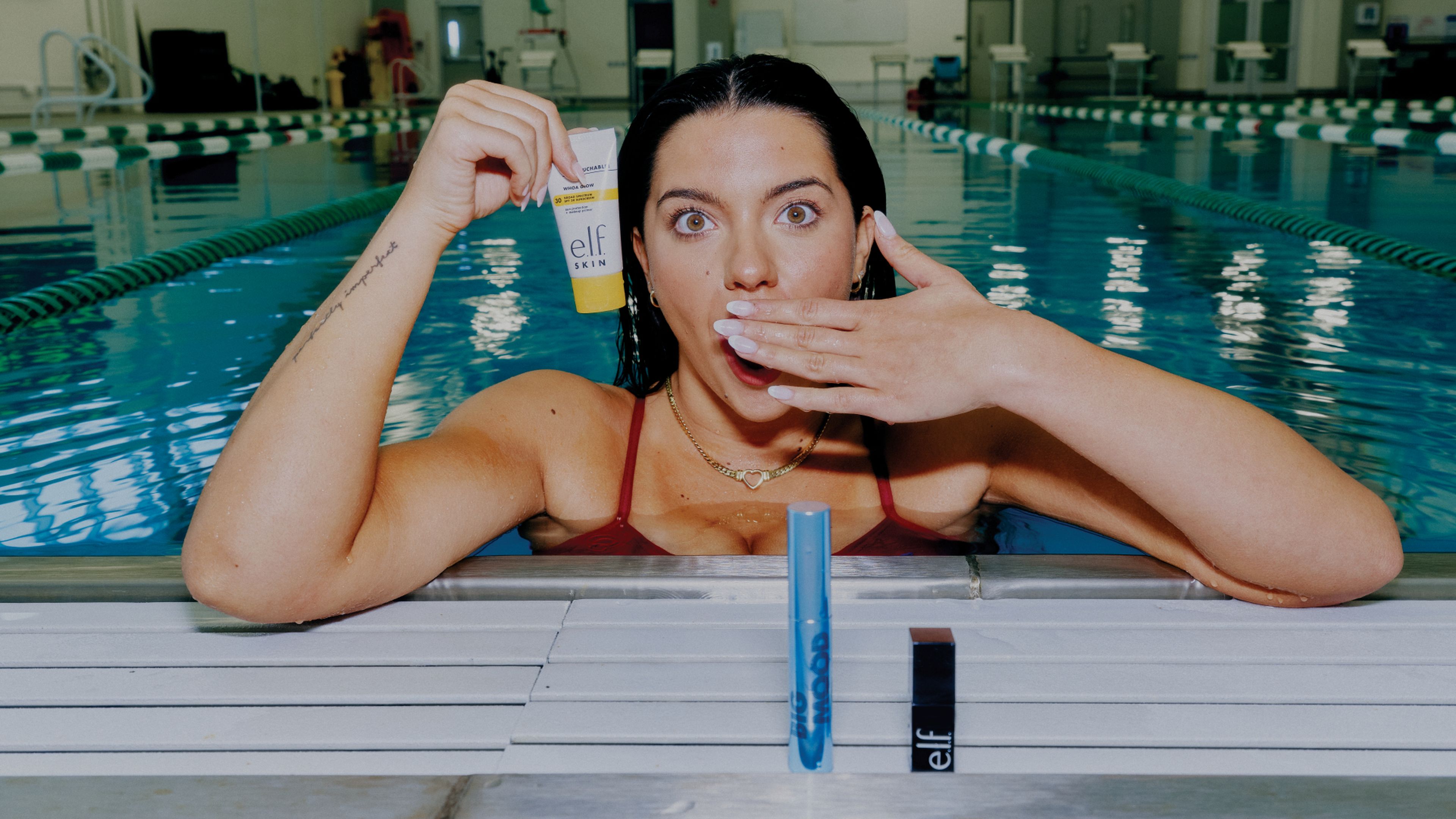 blind world champion swimmer anastasia pagonis holding up elf in a pool