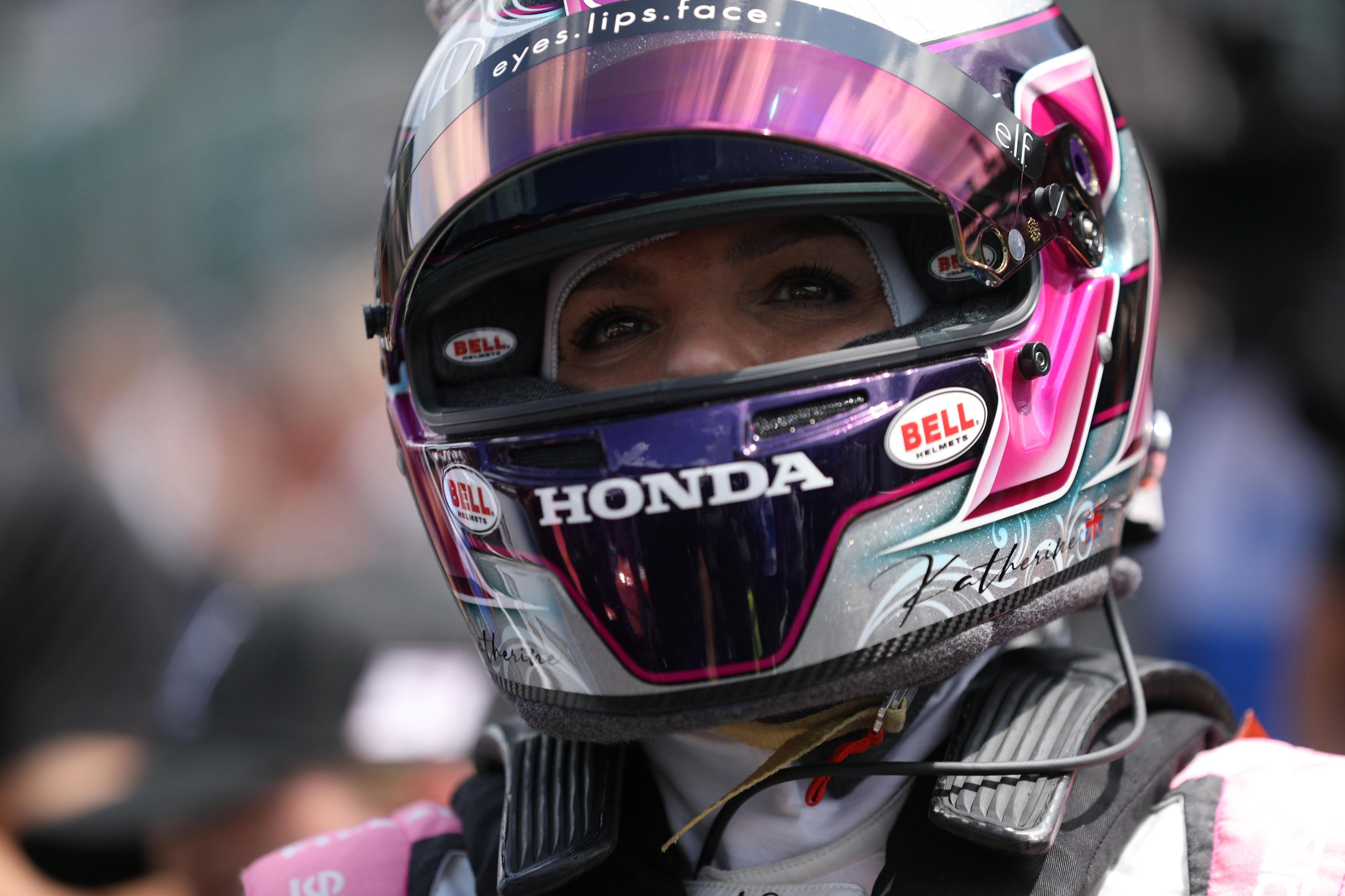 Katherine Legge wearing an elf sponsored racing helmet